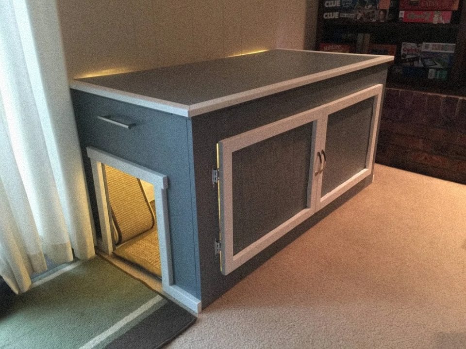 Hidden litter box cabinet that looks like a piece of furniture with a cat-sized side entry hole