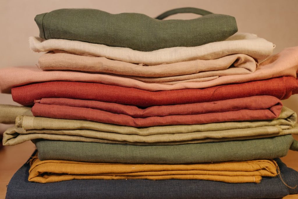 Neat stack of folded colorful fabrics like quilting fat quarter precuts