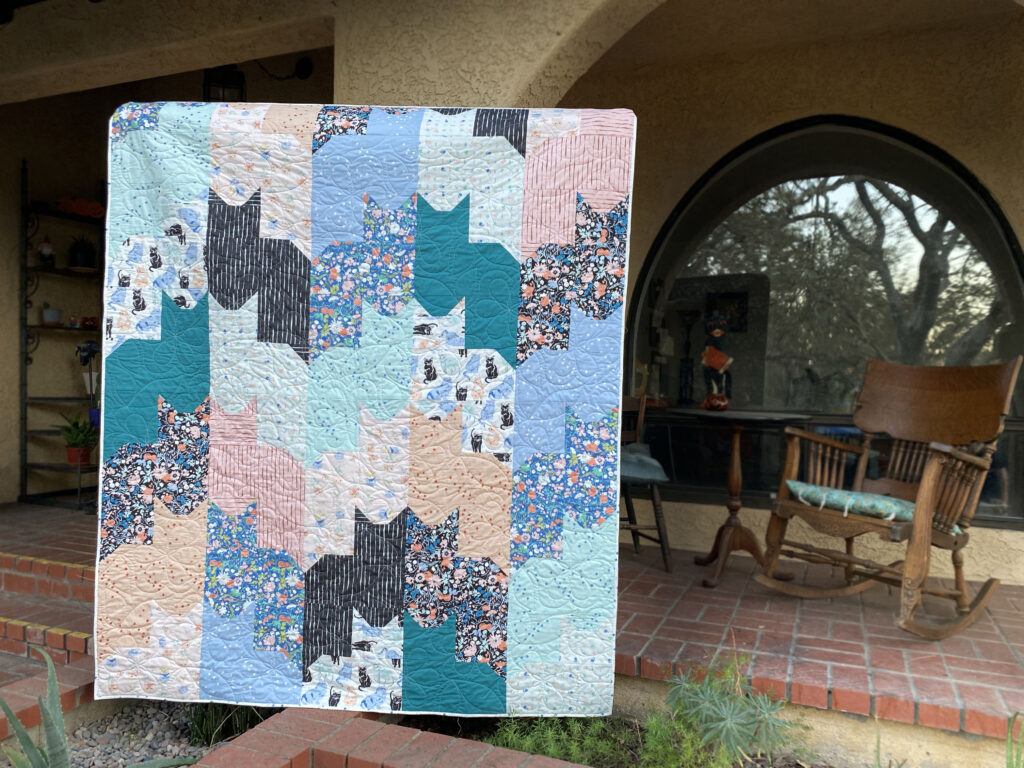 Cats on Cats quilt by Birch Fabrics with alternating pieced cat faces and bodies