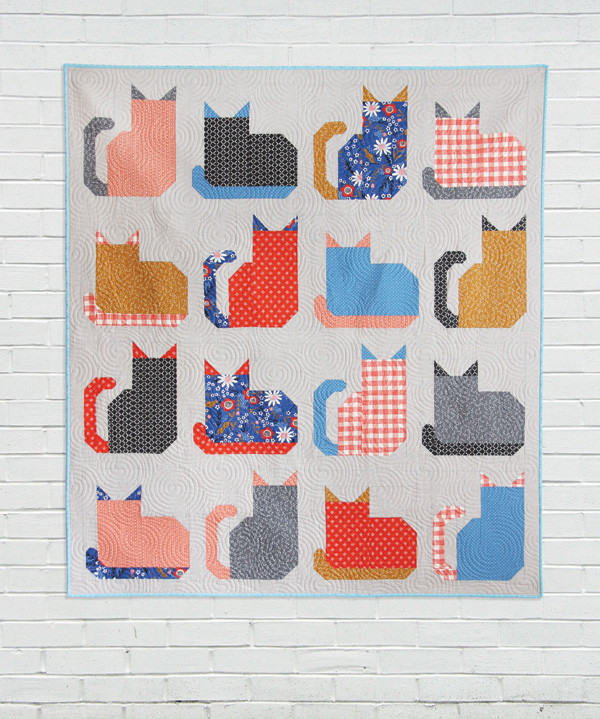 Kitty Cats quilt by Cluck Cluck Sew with 16 pieced cat blocks in coral, navy and gold